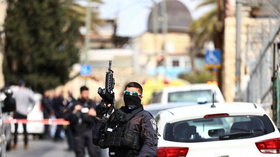 Israeli security personnel work near a scene where a suspected incident of shooting attack took place
