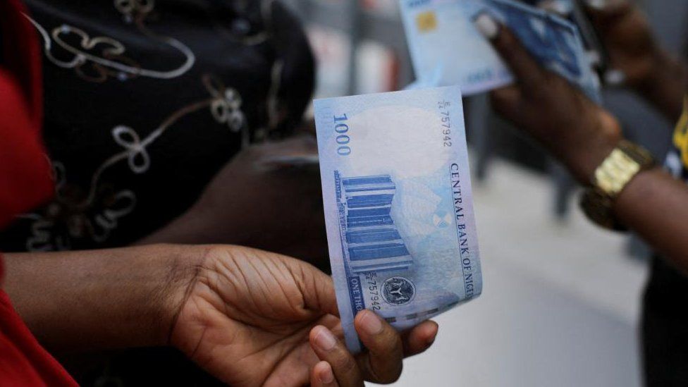 People holding the new 1,000 naira note in Abuja, Nigeria - 15 December 2022
