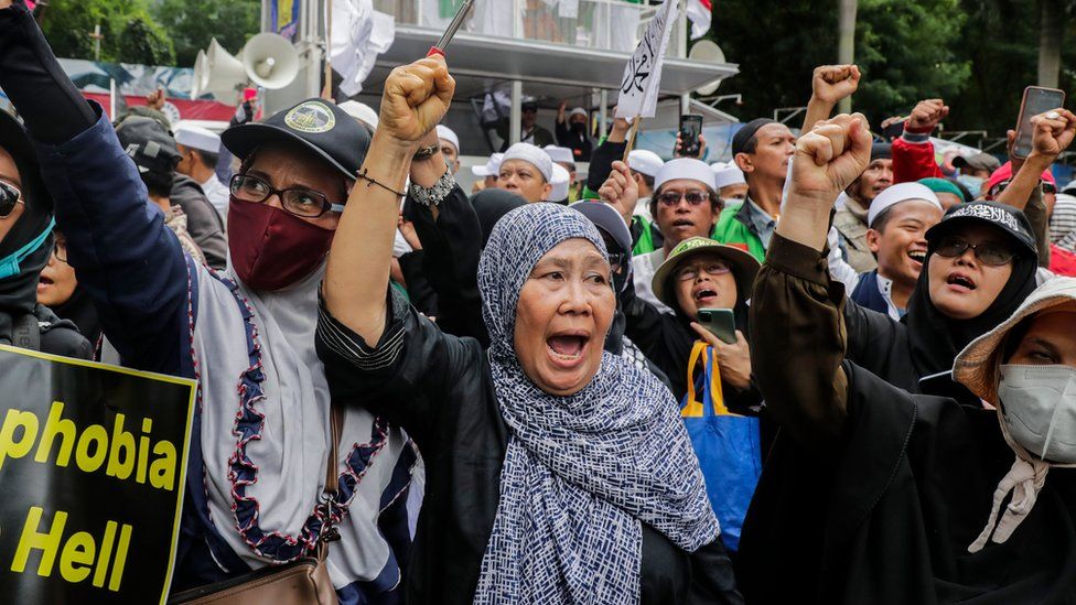 Muslim protesters hold placards and shout slogans during an anti-Sweden rally outside the Swedish embassy in Jakarta, Indonesia, 30 January 2023.