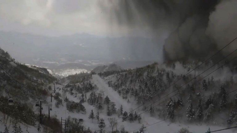 A cloud of black ash moves across a valley in Kusatsu, Japan