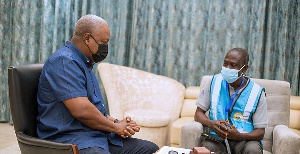 Former president, John Dramani Mahama with an official from the GSS