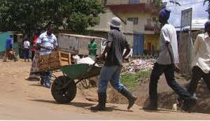 A load carrier with his wheelbarrow at a local market