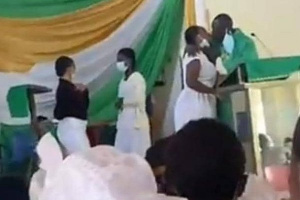 Screengrab of Rev Obeng Larbi kissing one of the girls