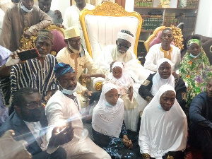 Family members of Kaaka in a group photograph with the Chief Imam