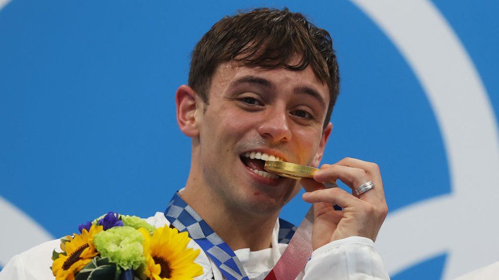 Tom Daley of Team Great Britain poses with the gold medal for the Men's Synchronised 10m Platform Final