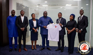 Mr.Kutor (third from right) presenting the Polo shirt to H:E Oquaye while other delegation looks on