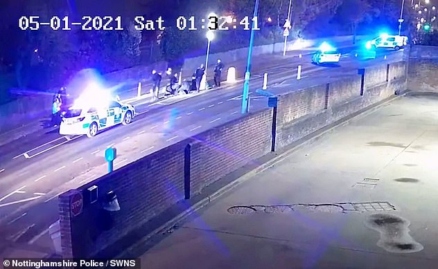 Nottinghamshire Police officers gather around the teenager following the staged crash