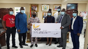 GCB officials (right) presenting a cheque to Volta Regional Minister