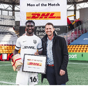 Emmanuel Ogura receives his Man of the Match award in Denmark