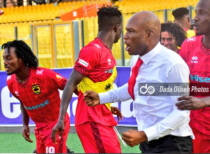 Asante Kotoko players celebrates with coach Prosper Narteh(White)