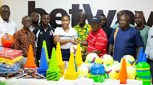 President of GHALCA presenting some items donated by Betway