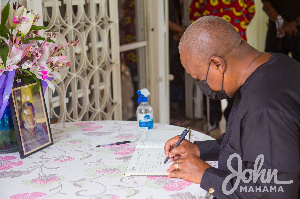 Former President, John Dramani Mahama signing the book of condolence