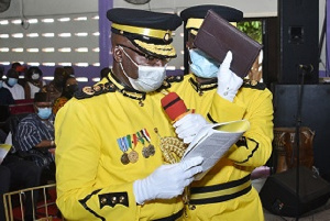 Mr. Isaac Kofi Egyir with a Bible being sworn into office