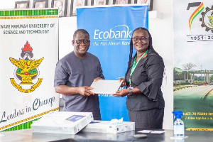 Ecobank official hands over the first laptop to VC of KNUST