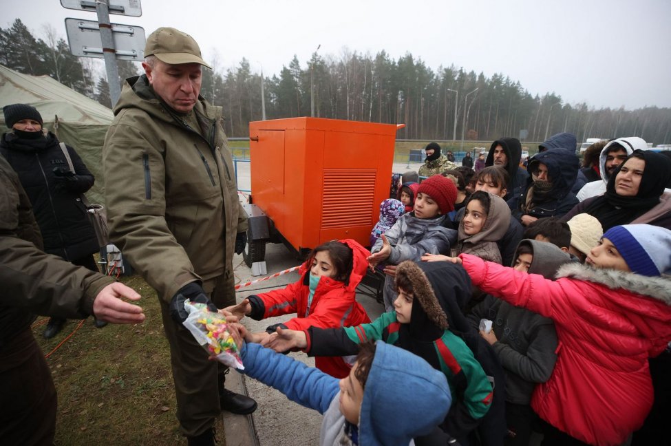 Belarus shelters hundreds of refugees after clashes at border with Poland