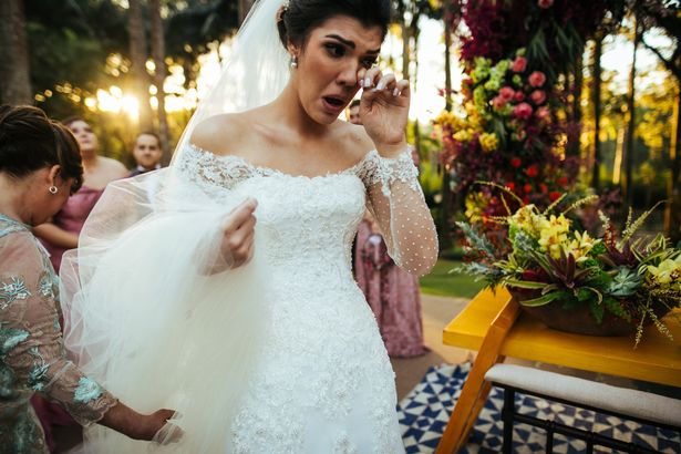 A bride crying and wiping her tears
