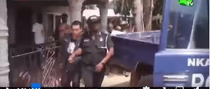 The suspect being led away by the police