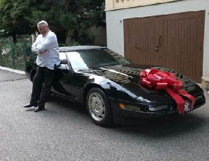 Jerry John Rawlings poses beside the car