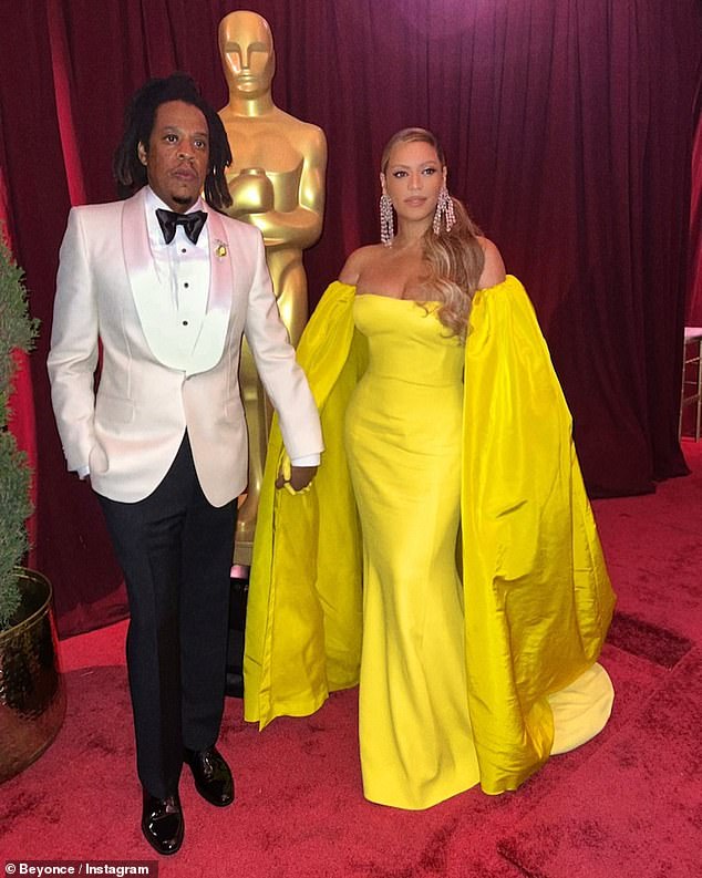 Lovely lady on Oscar night: Beyonce's gown was curve-hugging as it came in at the waist and had a slight mermaid finish while in went to the floor