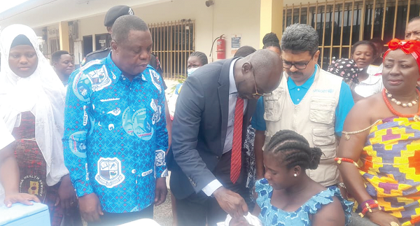 Fred Adomako-Boateng, the Bono East Regional Director of Health, immunising a baby during the launch of the  second round of mass polio vaccination for children under five years