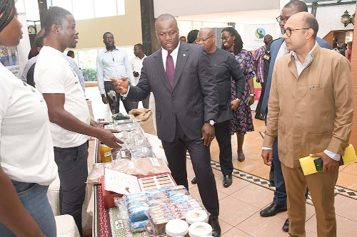 Samuel Abu Jinapor (arrowed), Minister of Lands and Natural Resources, with Richard Razaarly (right), EU Ambassador to Ghana, at an exhibition stand at the Orange Cocoa Day 2022. Picture: EBOW HANSON