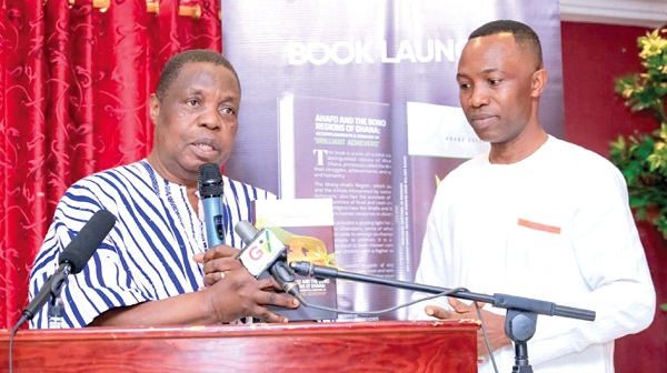  Kwasi Adu-Gyan (left), the Bono East Regional Minister, launching the book. With him is Anana Adjei, the author 