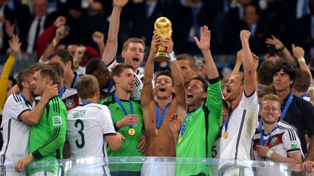 Mesut Ozil lifting the World Cup alongside his Germany team-mates in 2014
