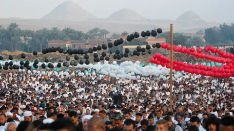 Reuters People gathered under balloons in the colours of the Palestinian flag in at the village of Abu Sir, in the Giza Governorate, Egypt.