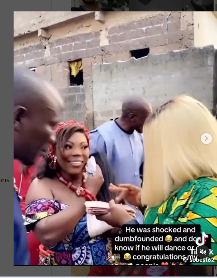 Lady shares video of her turning up for her ex-boyfriend’s wedding and spraying him and his wife money