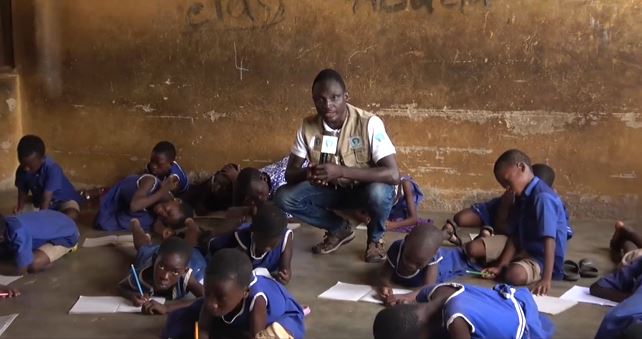 Pupils of Yapei Presby Primary School lie on bare floor to study