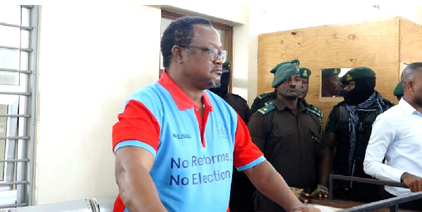 Lissu appears in court with “No Reforms, No Election” slogan amid objection from prosecution