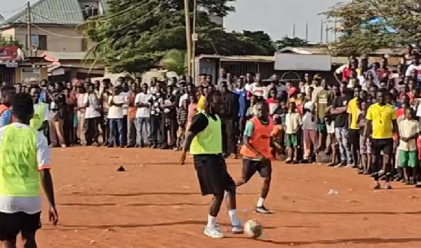 Man City’s Jeremy Doku plays football with locals on dusty Madina pitch